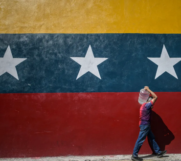 A man carrying a drum of water, Caracas, Venezuela, January 2025